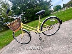 Yellow vintage Schwinn breeze bicycle with removable basket