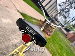 Yellow vintage Schwinn breeze bicycle with removable basket