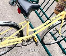 Yellow vintage Schwinn breeze bicycle with removable basket