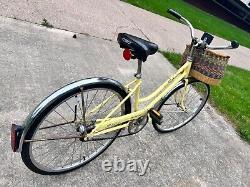 Yellow vintage Schwinn breeze bicycle with removable basket